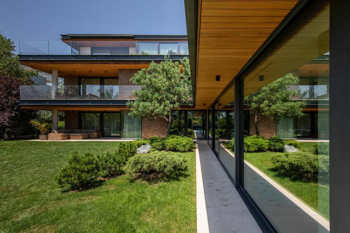 The Romanian M House villa, complete with luscious green garden.