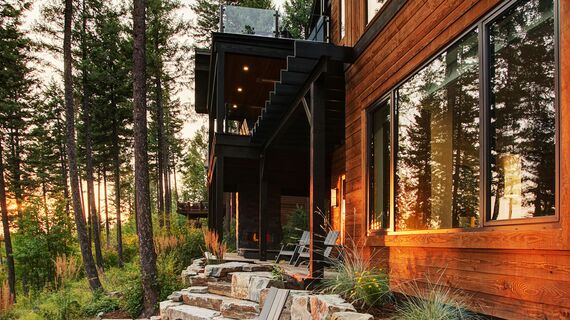Sunset on private home in the woods, featuring aluminium windows.
